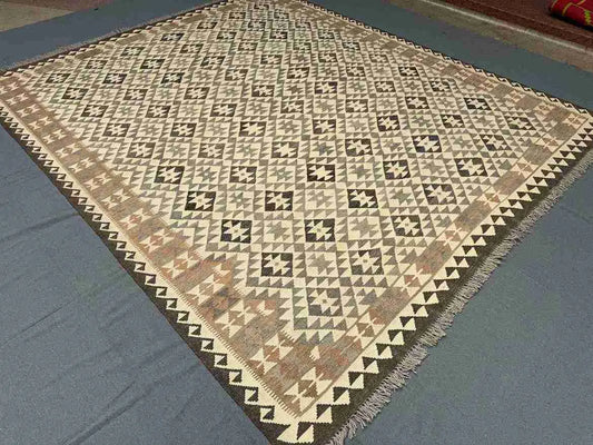  Handmade geometric Turkish rug styled on floor – knotted wool with earthy tones.