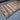 Geometric area rug laid on floor with vibrant red-green tones