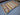  Geometric area rug laid on floor with vibrant red-green tones