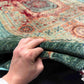 Front view of 6x8 handmade wool & silk Mamluk rug held in hands