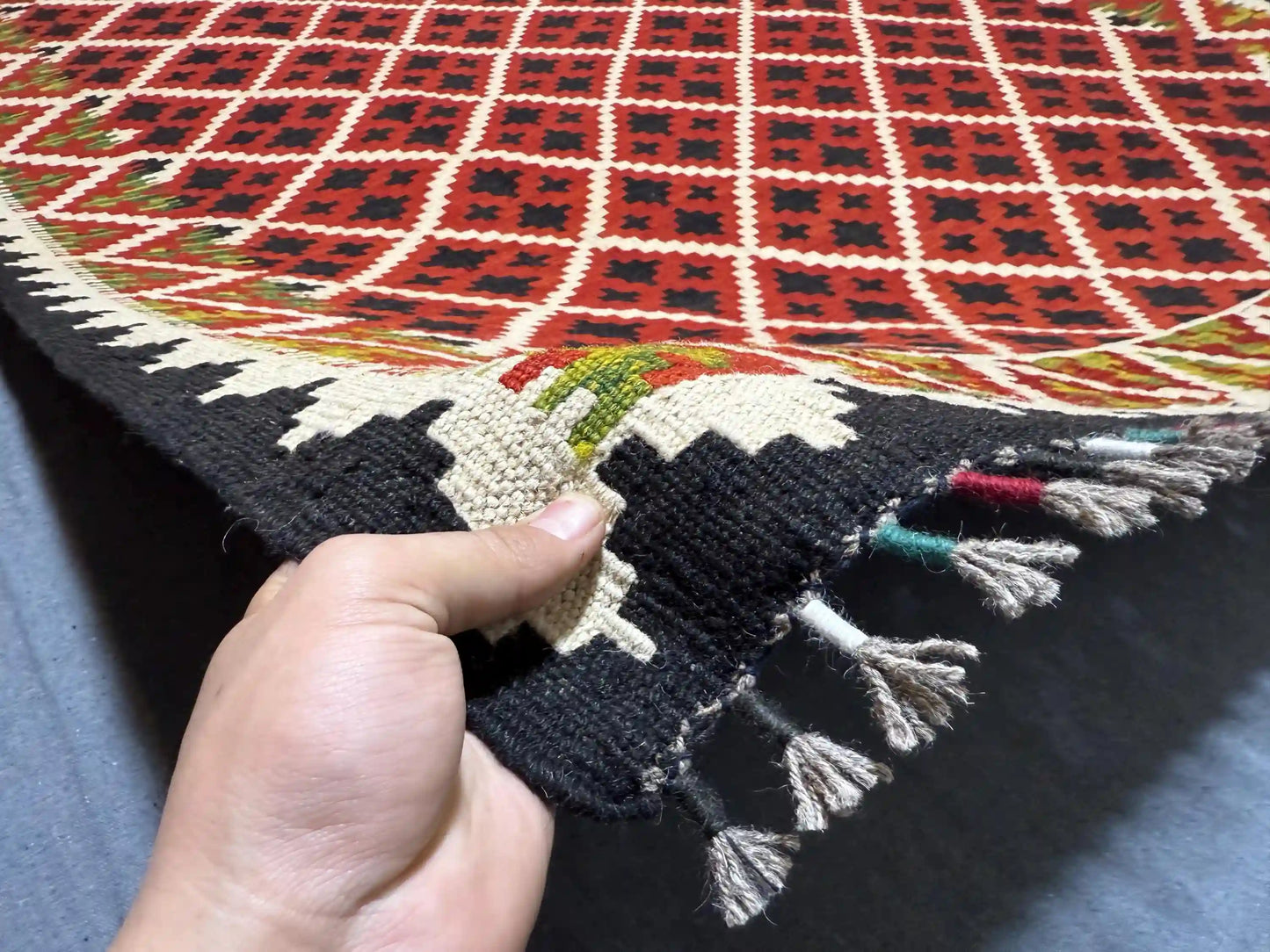 Authentic handmade red kilim rug 5x7 ft shown in hands – wool flatweave tribal carpet