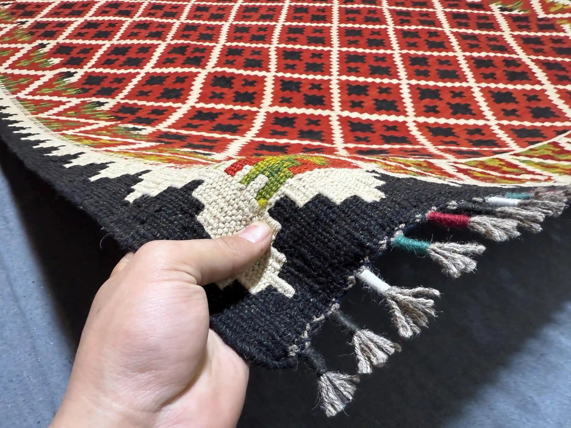 Authentic handmade red kilim rug 5x7 ft shown in hands – wool flatweave tribal carpet