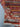 Folded view showing edge and backing of Afghan mini rug