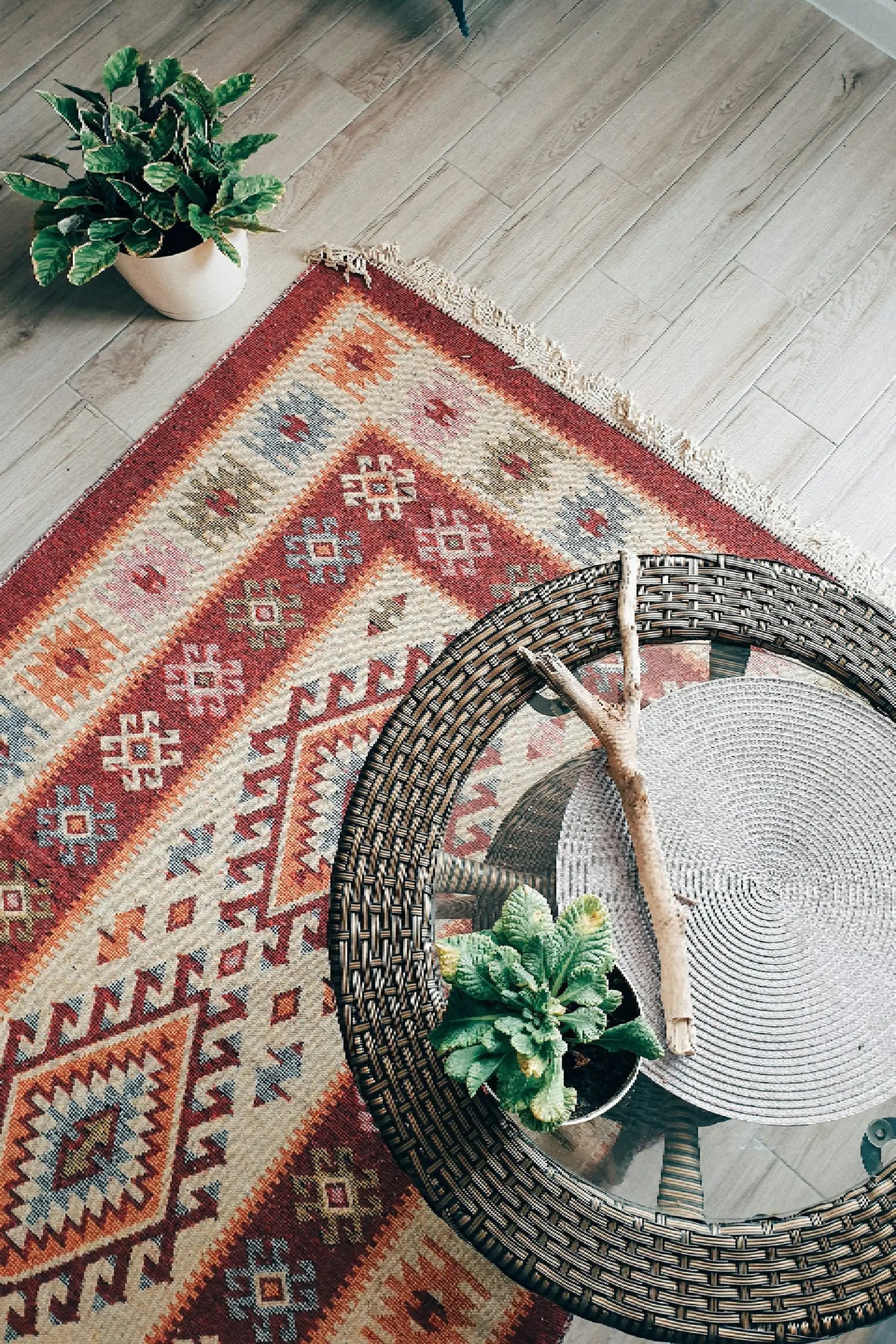 Handwoven area rug placed under a wooden table in a modern living room setting