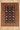A rectangular traditional area rug with a dark navy blue center field, decorated with repeating diamond motifs and ornate borders in red, beige, and gold, laid out on a light gray wood floor.