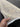 Artisan holding 3x13 handmade pastel Oushak runner rug