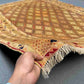 Handwoven 5x6.2 Afghan Turkish rug held in hands showing wool texture and beige, gold & brown tribal geometric design