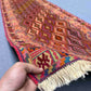 Handwoven Turkish kilim runner rug held to show soft wool and tribal design
