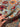  In-hand view of authentic handmade Turkish blue and red wool rug with floral pattern