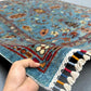 Handmade 5x7 Sultani wool rug in hands – Persian style rug texture