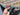 In-hands view of large multicolor handmade Turkish Kilim rug 6'8 x 9'10