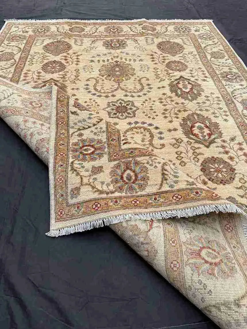 Folded view showing backside texture of handmade 5x7 Chobi rug.