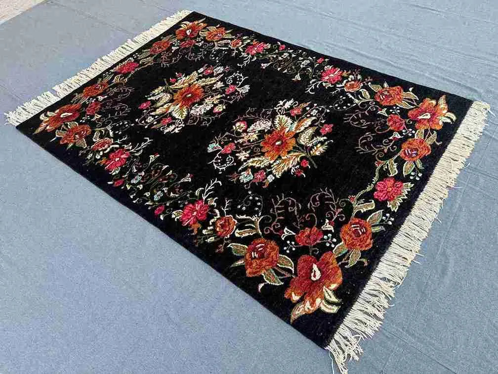 Karabakh vintage floral rug on floor in bohemian-styled home interior
