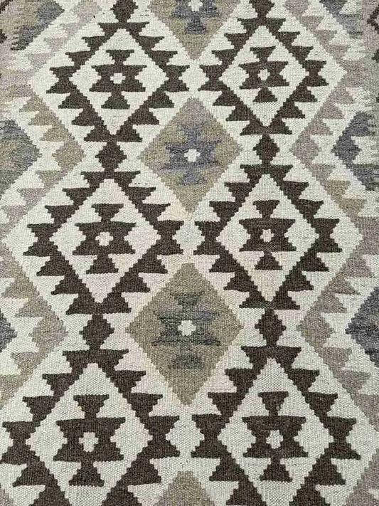 Detail of beige and brown colors in handmade kilim rug