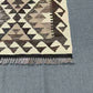 Corner detailing of handmade beige and brown Kilim rug