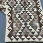 Side view of folded Kilim wool runner – handmade carpet texture