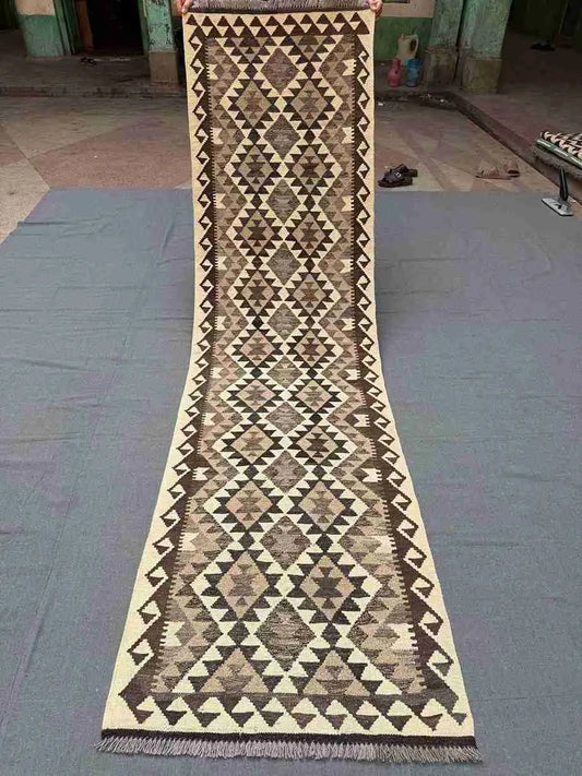 Full view of 2x9 flatweave Kilim runner rug in neutral colors