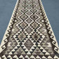 Flatweave Kilim runner on rustic hallway floor – boho décor