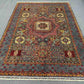 Knotted wool and silk rug in earthy color palette placed on home floor