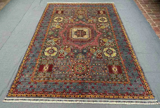 Knotted wool and silk rug in earthy color palette placed on home floor