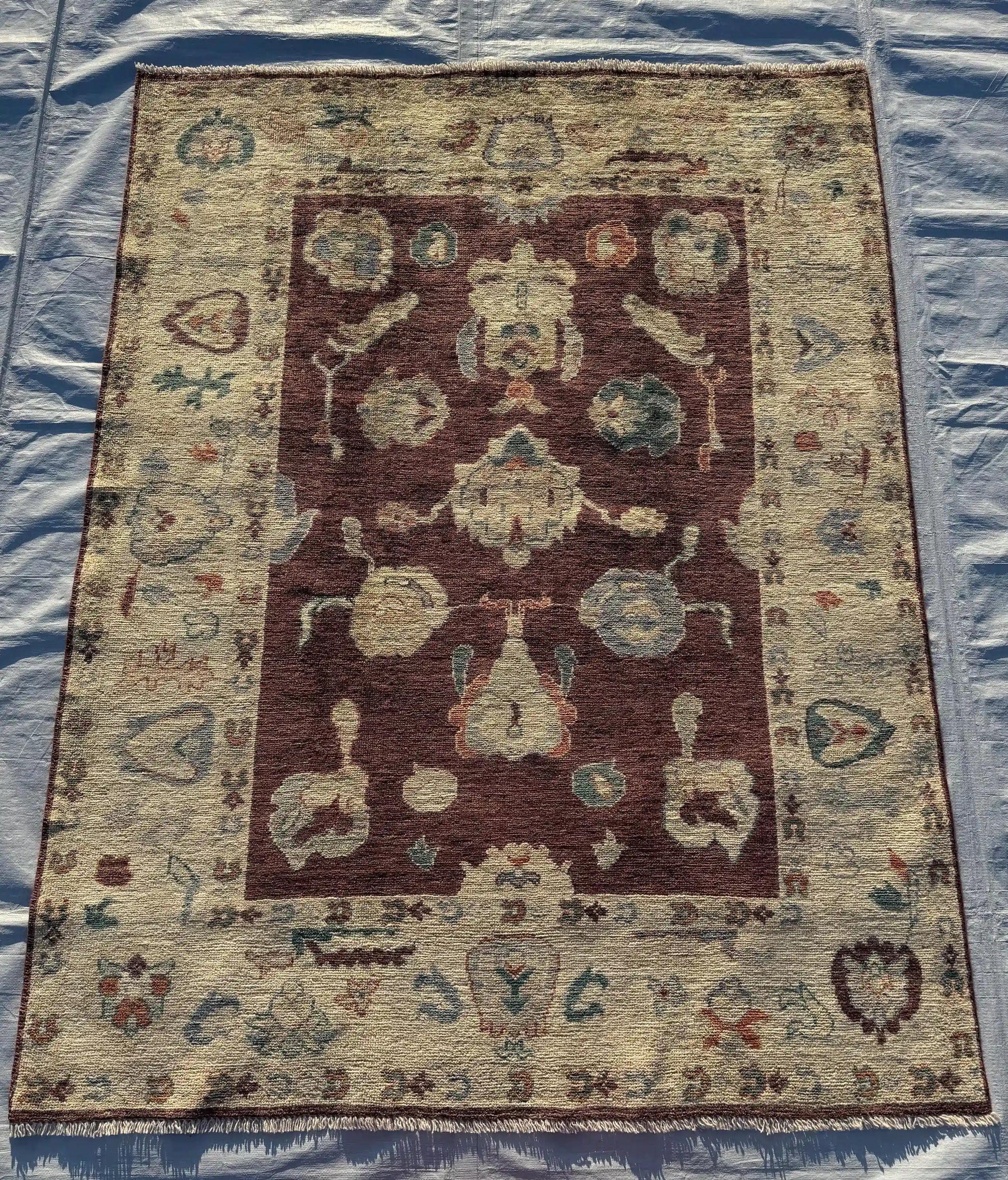 Flatlay view of large 5x7 Oushak wool area rug with vintage styling