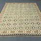 Large 8x10 Kilim rug placed in modern rustic interior – traditional wool flatweave.