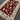 Large red Oriental rug laid flat on wooden floor – side angle