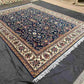 Wide-angle view of Persian Chobi rug laid out on wooden floor