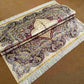 Folded handmade silk rug displaying texture and quality