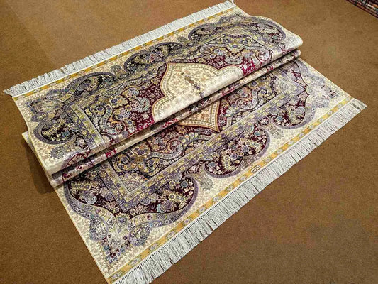 Folded handmade silk rug displaying texture and quality