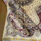 Folded handmade silk rug displaying texture and quality
