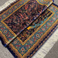  Side fold of hand-knotted Persian silk rug showing pile quality