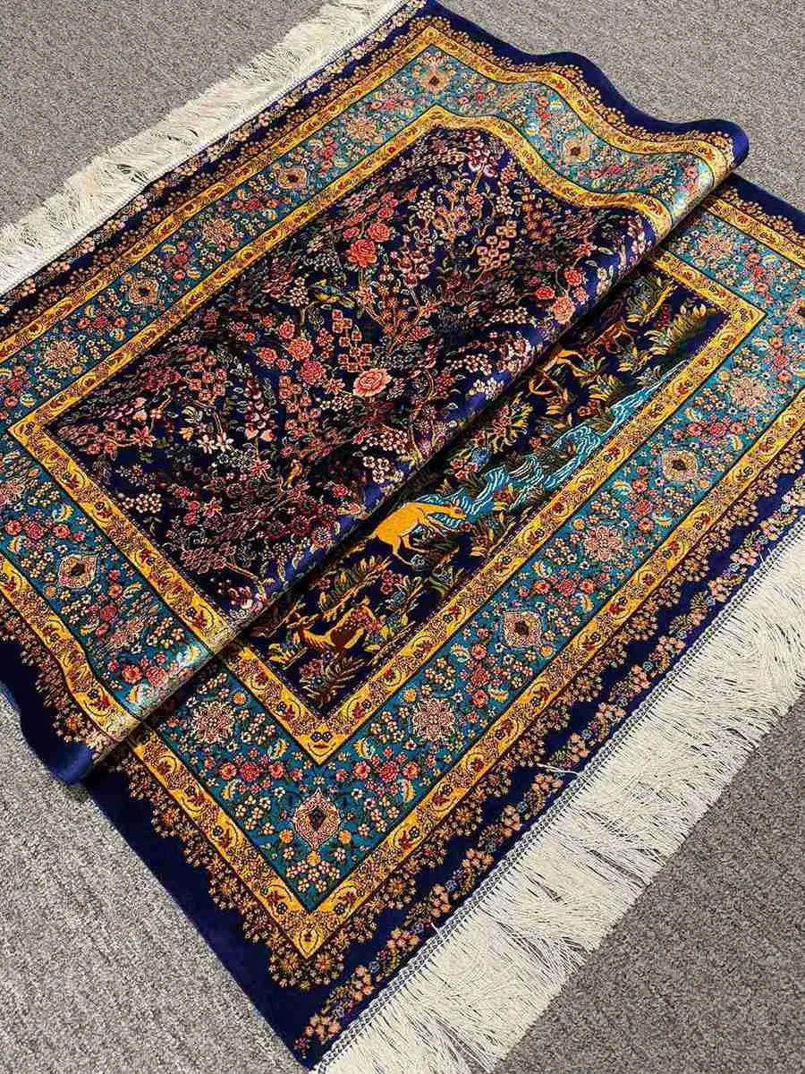  Side fold of hand-knotted Persian silk rug showing pile quality