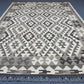 Monochrome Kilim rug enhancing boho-modern interior space.