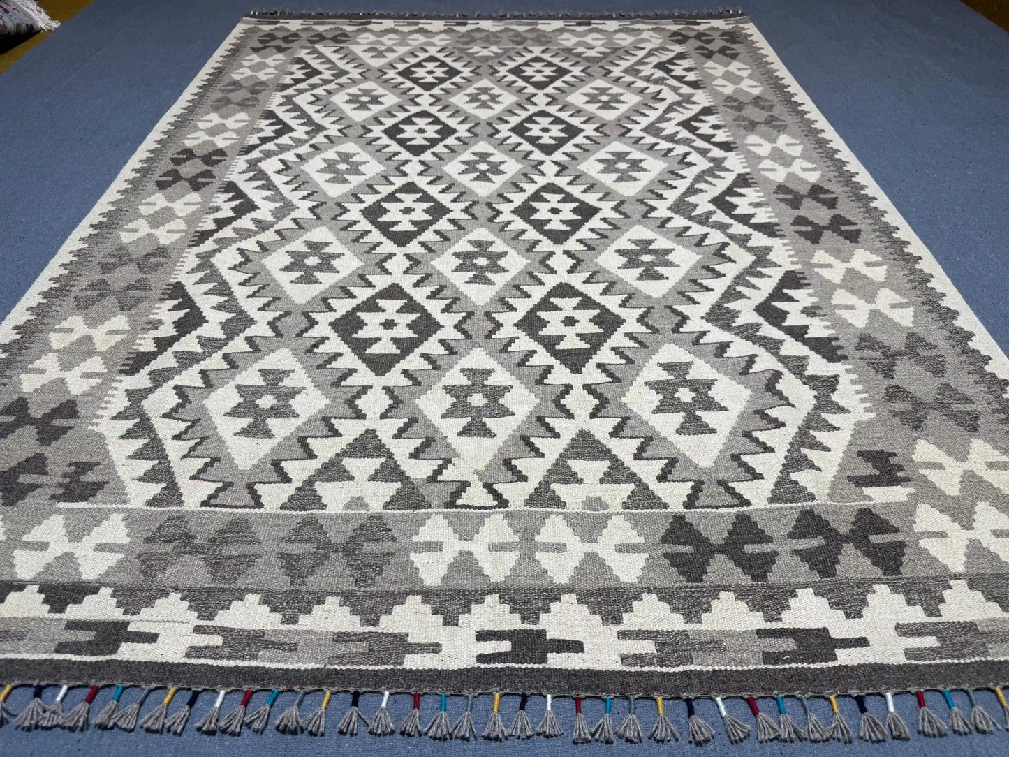 Monochrome Kilim rug enhancing boho-modern interior space.