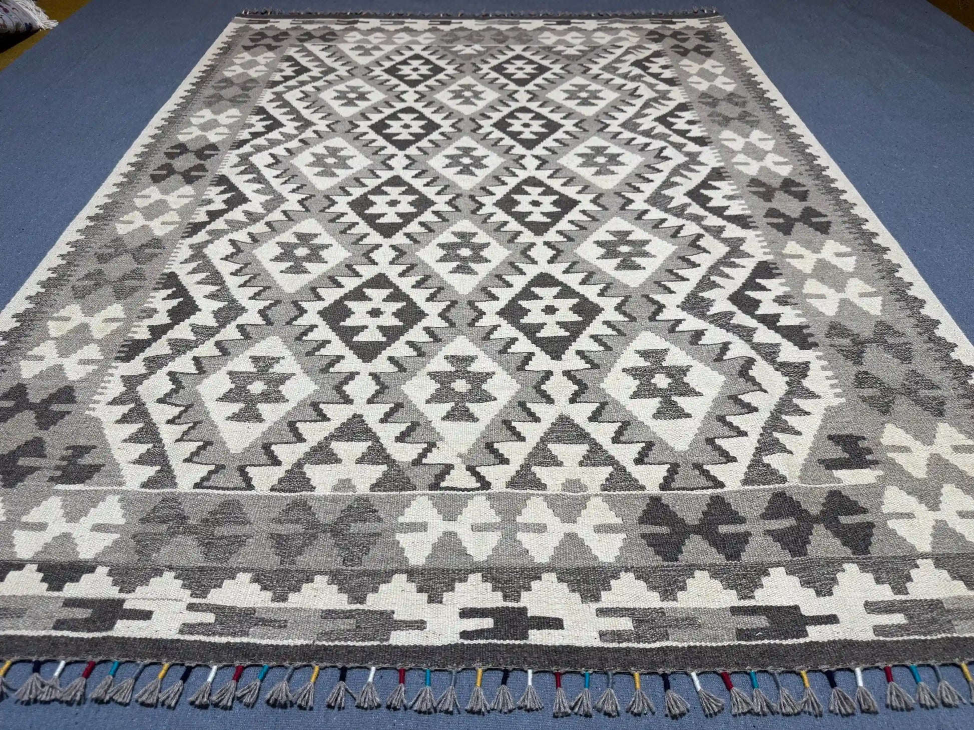 Monochrome Kilim rug enhancing boho-modern interior space.