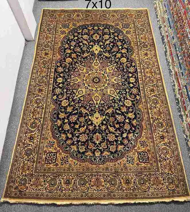 Full view of Persian Nain rug on floor with floral medallion