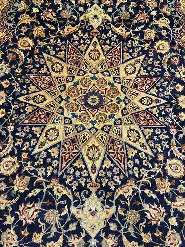 Close-up of Persian Nain rug floral medallion design in wool