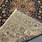 Folded Persian Nain rug showing thickness and texture