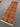 Orange Sultani runner rug styled on hardwood floor