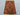 Red and gold Afghan rug styled on wooden floor with bohemian decor