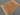 Top-down view of handwoven oriental rug placed on wood floor