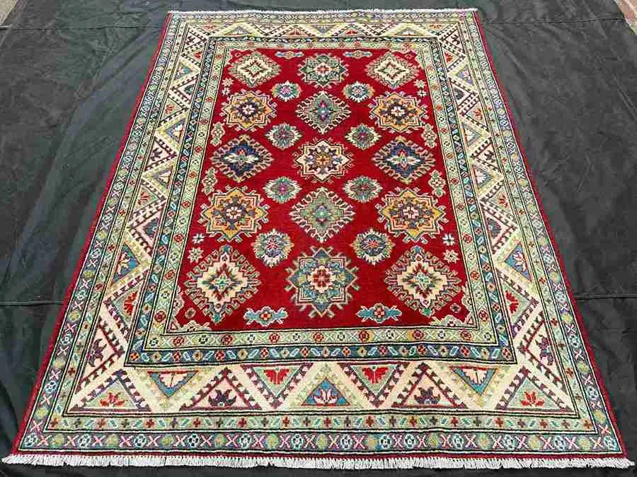 Oriental carpet in red & beige styled on floor for home décor