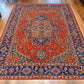 Oriental red and blue rug styled in cozy living room