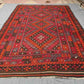 Large oriental Turkish rug with tribal design laid on floor – 8x12 wool flatweave Kilim.