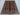 Wool silk Oriental rug styled in home with red and blue tribal pattern