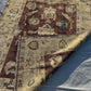  Side view of folded handmade Oushak rug 5x7 ft showing handwoven texture