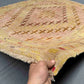 Handmade pastel Persian Afghan kilim rug in hand showing fine wool weave