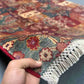 Handmade patchwork rug in hand showing colorful Persian wool panels