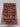3x4 red and navy handmade Pazyryk carpet styled in a small room